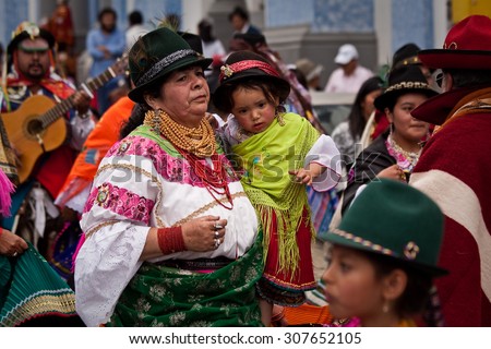 PICHINCHA, ECUADOR - JUNE 30, 2011: Unidentified indigenous woman with her child at Inti Raymi indigenous celebration in Cayambe, Ecuador