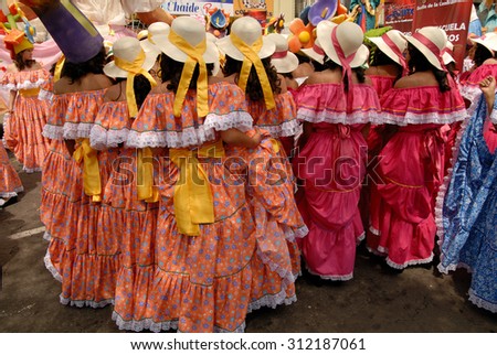 QUITO, ECUADOR - DECEMBER 5, 2010: Group of women dressed up with colorful dresses for the Quito Festivities\' parade