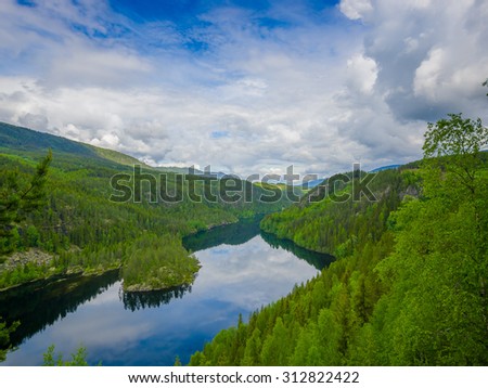 VALDRES, NORWAY - 6 JULY, 2015: Beautiful view over Begna river seen from above, large green forest and dark blue water nice weather.