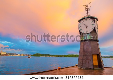 OSLO, NORWAY - 8 JULY, 2015: Charming small clocktower located at Aker Brygge pier during sunset hour.