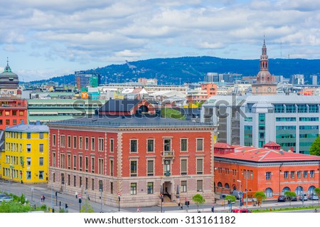 OSLO, NORWAY - 8 JULY, 2015: Great view from roof of opera building showing famous ski-jump hill Homenkollen in the distant green hillside.