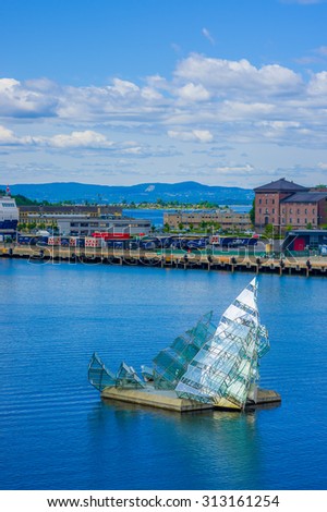 OSLO, NORWAY - 8 JULY, 2015: Triangular art installation in water outside spectacular opera building.
