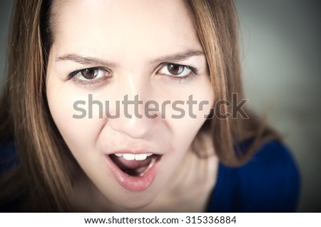 closeup portrait of young beautiful teen girl\'s face looking surprised
