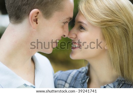 Smiling Profile Of Teenage Boy And Girl Touching Noses Stock Photo ...