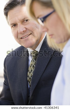 Portrait of a Smiling Businessman Looking at a Co-Worker
