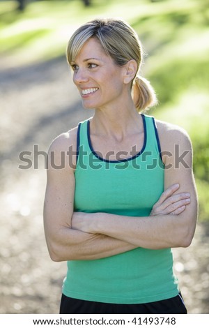 Pretty Athletic Woman Standing Outdoors Looking Away From Camera
