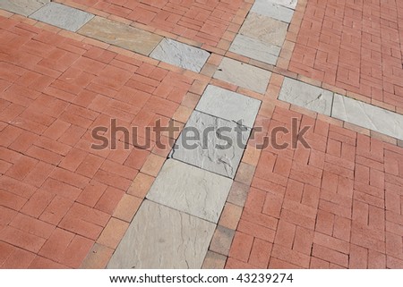 Detail of a Red Brick Sidewalk with an Intersection of Gray Slate Squares