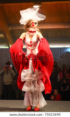 RIGA, LATVIA - APRIL 10: A model wears extravagant bridal fashions on the catwalk during the wedding and fashion show at Fiesta Expo 2011 on April 10, 2011 in Kipsala Hall in Riga, Latvia.