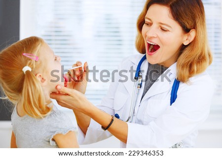 Pediatrician doctor examining little girl.