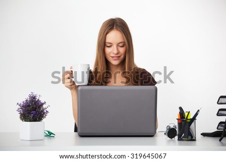 Portrait of young beautiful business woman working at her office.