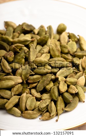 Pile of dried green cardamom seed pods. A popular curry and dessert flavouring in oriental food.