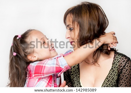 Romanian 28 year old mother and six year old daughter smiling and happy together