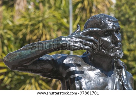 Head, arms and shoulders of the bronze statue Jaques de Wissant, 1888 by Rodin displayed in Murcia, Spain, in the open air with blue reflections from the blue sky  The Thinker.