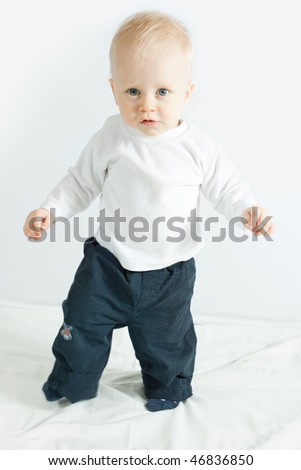 little boy making his first steps - on white
