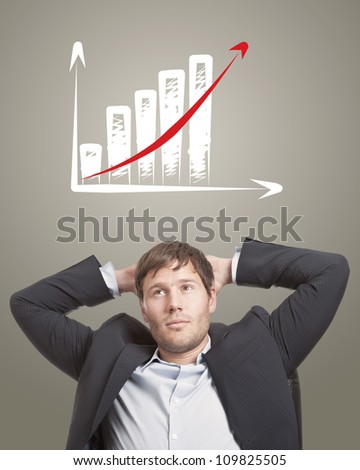 Business man in chair thinking with a rising chart diagram over his head