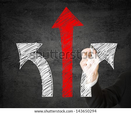 Businessman with pen drawing arrows - decision or strategy concept