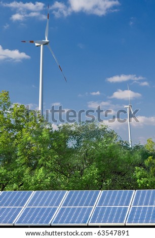 Solar panel and wind mill in front of blue sky - alternative energy sources concept