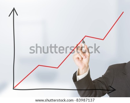 Young business man drawing rising graph - entrepreneur or start-up concept