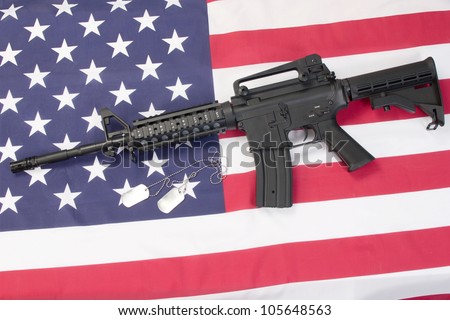 us army carbine with blank dog tags on us flag