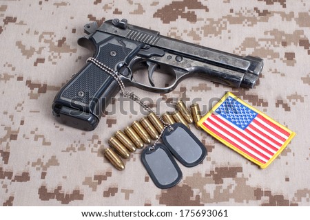 Beretta hand gun on  desert marines uniform