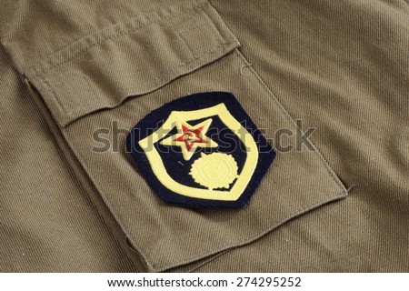 Soviet Army Chemical Corps shoulder patch on khaki uniform background