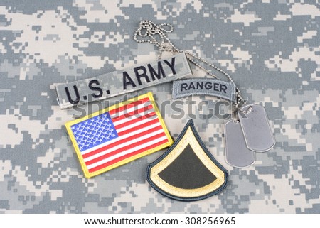 KIEV, UKRAINE - August 21, 2015. US ARMY Private First Class rank patch, ranger tab, flag patch,  with dog tag on camouflage uniform