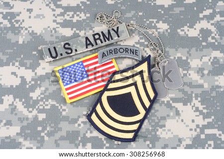 KIEV, UKRAINE - August 21, 2015. US ARMY Master Sergeant rank patch, airborne tab, flag patch,  with dog tag on camouflage uniform