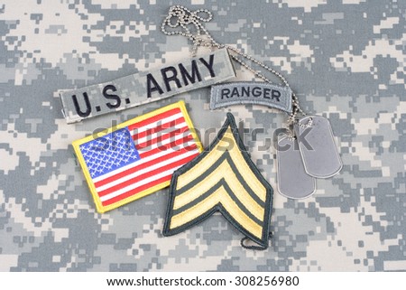 KIEV, UKRAINE - August 21, 2015. US ARMY Sergeant rank patch, ranger tab, flag patch,  with dog tag on camouflage uniform