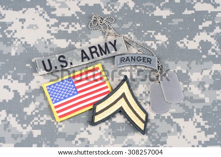 KIEV, UKRAINE - August 21, 2015. US ARMY Corporal rank patch, ranger tab, flag patch,  with dog tag on camouflage uniform