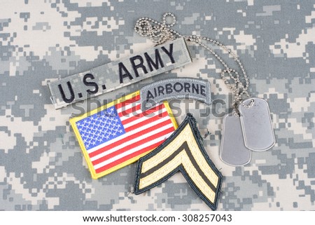 KIEV, UKRAINE - August 21, 2015. US ARMY Corporal rank patch, airborne tab, flag patch,  with dog tag on camouflage uniform