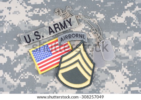 KIEV, UKRAINE - August 21, 2015. US ARMY Staff Sergeant rank patch, airborne tab, flag patch,  with dog tag on camouflage uniform