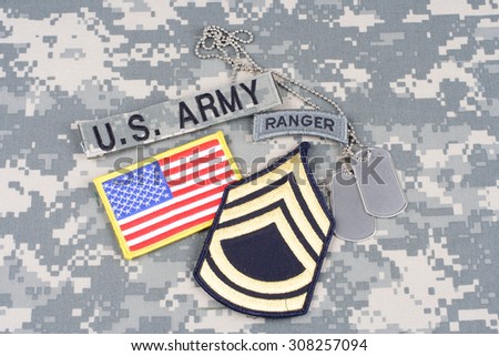 KIEV, UKRAINE - August 21, 2015. US ARMY Sergeant First Class rank patch, ranger tab, flag patch,  with dog tag on camouflage uniform