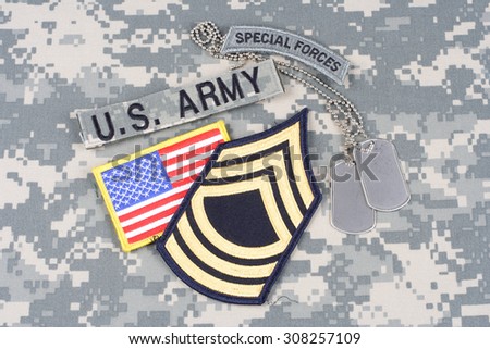 KIEV, UKRAINE - August 21, 2015. US ARMY Master Sergeant rank patch, special forces tab, flag patch,  with dog tag on camouflage uniform