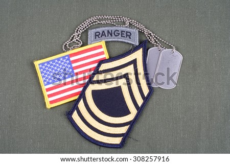 KIEV, UKRAINE - August 21, 2015.  US ARMY Master Sergeant rank patch, ranger tab, flag patch and dog tag on olive green uniform