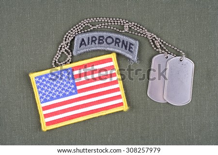 KIEV, UKRAINE - August 21, 2015. US ARMY airborne tab with dog tag and flag patch on olive green uniform