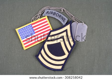KIEV, UKRAINE - August 21, 2015.  US ARMY Master Sergeant rank patch, airborne tab, flag patch and dog tag on olive green uniform