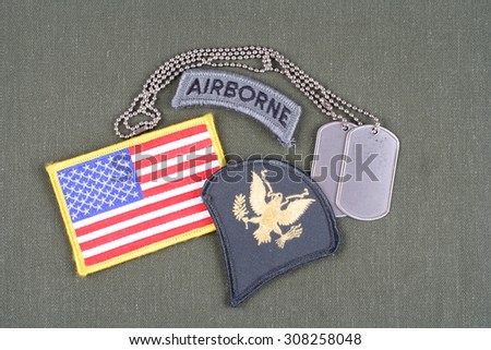 KIEV, UKRAINE - August 21, 2015.  US ARMY Specialist rank patch, airborne tab, flag patch and dog tag on olive green uniform