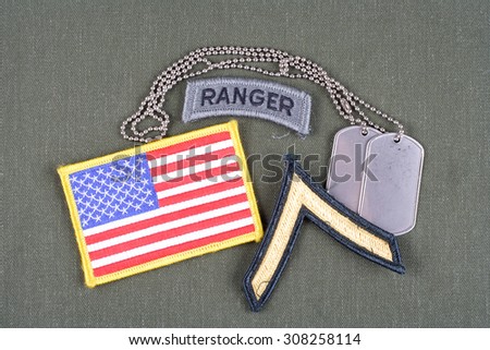 KIEV, UKRAINE - August 21, 2015.  US ARMY Private rank patch, ranger tab, flag patch and dog tag on olive green uniform