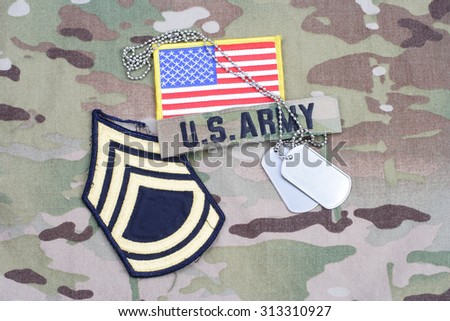 KIEV, UKRAINE - September 5, 2015. US ARMY Sergeant First Class rank patch,  flag patch, with dog tag on camouflage uniform