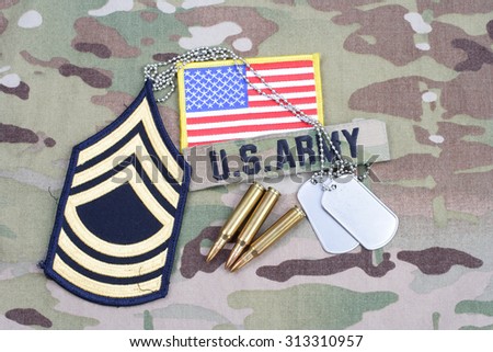 KIEV, UKRAINE - September 5, 2015. US ARMY Master Sergeant rank patch, flag patch,  with dog tag with 5.56 mm rounds on camouflage uniform