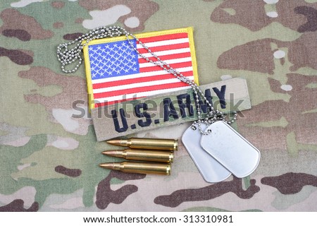 KIEV, UKRAINE - September 5, 2015. US ARMY flag patch, with dog tag with 5.56 mm rounds on camouflage uniform