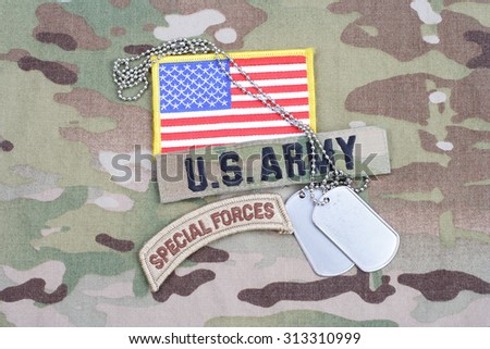 KIEV, UKRAINE - September 5, 2015. 2015. US ARMY special forces tab, flag patch,  with dog tag on camouflage uniform