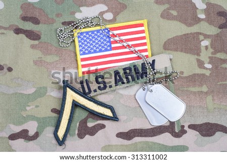 KIEV, UKRAINE - September 5, 2015. US ARMY Private rank patch,  flag patch, with dog tag on camouflage uniform