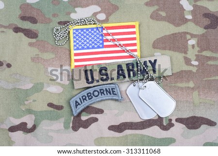 KIEV, UKRAINE - September 5, 2015. US ARMY airborne tab, flag patch,  with dog tag on camouflage uniform