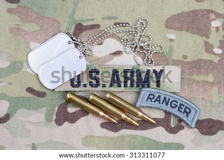 KIEV, UKRAINE - September 5, 2015. US ARMY ranger tab, flag patch,  with dog tag and 5.56 mm rounds on camouflage uniform