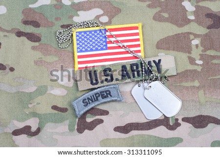 KIEV, UKRAINE - September 5, 2015. US ARMY sniper tab, flag patch,  with dog tag on camouflage uniform