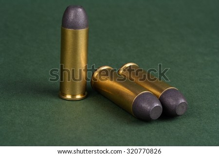 The .45 Revolver cartridges Wild West period on green background
