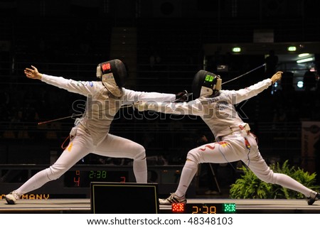 TURIN - FEB 7: Women Foil World Cup, Chinese fencer DAI Huili fight against german fencer BINGENHEIMER Sandra during semifinal match of team tournament on  February 7, 2010 in Turin, Italy.