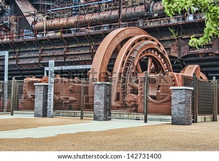 A very large steel flywheel at an abandoned steel mill