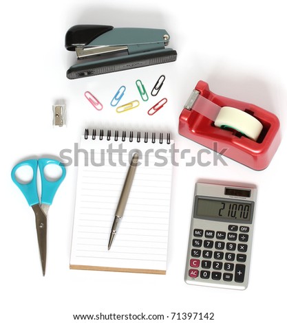 stationery supplies consisting of stapler scissors notebook pen calculator paper clips and pencil sharpener isolated on white background